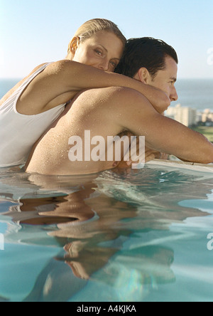 Woman embracing man in pool Stock Photo