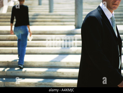 Businessman standing in front of stairs Stock Photo