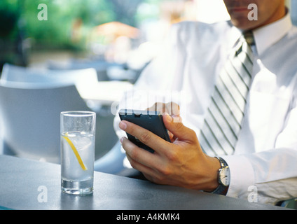 Businesman using electronic organizer in restaurant Stock Photo