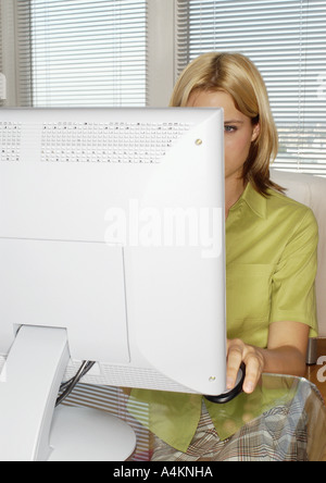 Young female using computer Stock Photo