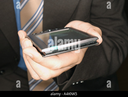 Businessman holding electronic organizer, close-up Stock Photo