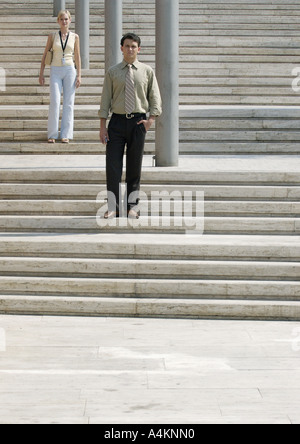 Man and woman standing on stairs outside Stock Photo