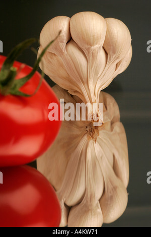 Single garlic clove and tomato Stock Photo - Alamy