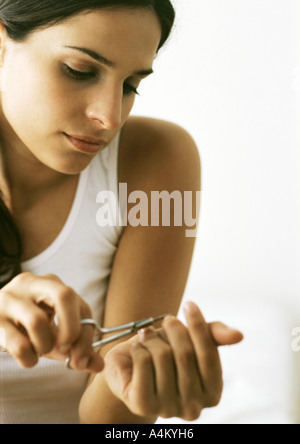 Woman cutting nails with nail scissors Stock Photo