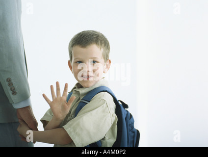 Boy holding man's hand, waving Stock Photo