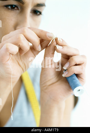 Woman threading needle Stock Photo