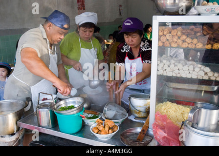 A chef preparing laksa and noodles at a restaurant in Ipoh Malaysia Stock Photo