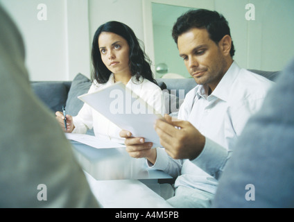 Young adults examining documents Stock Photo