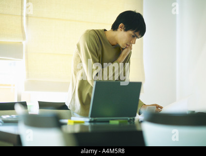 Young man using phone and laptop