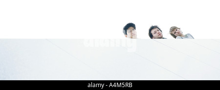 Young people at rooftop edge looking down, low angle view Stock Photo