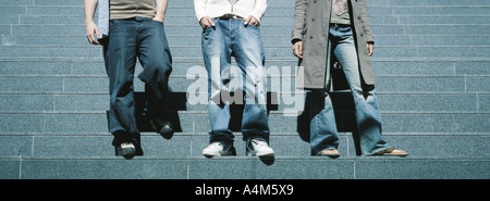 Young people standing on steps, waist down Stock Photo