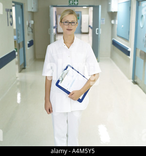 Nurse standing in hospital corridor Stock Photo