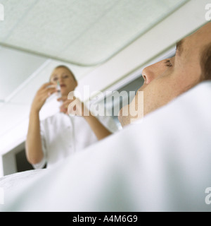 Nurse standing over patient Stock Photo