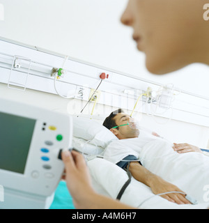 Nurse checking patient's monitor Stock Photo