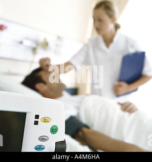 Nurse checking on patient Stock Photo