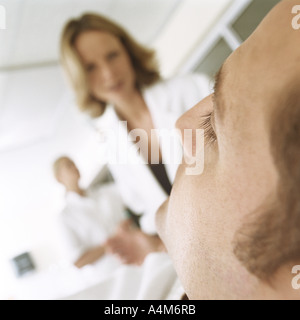 Doctor looking down at patient Stock Photo