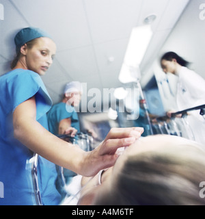 Medical team transporting patient on gurney Stock Photo