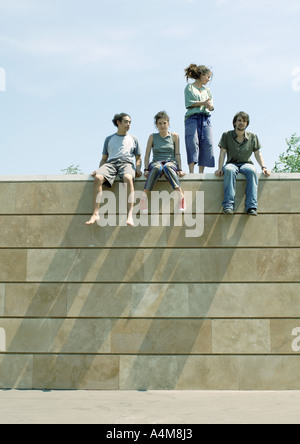 Young people on top of wall Stock Photo