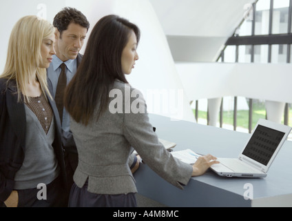 Three businesspeople using laptop Stock Photo