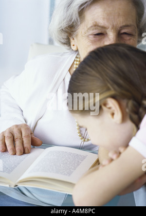 Grandmother and girl with book Stock Photo
