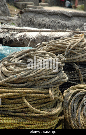 Rope piles on beach by fishing boats in Kerala India Stock Photo