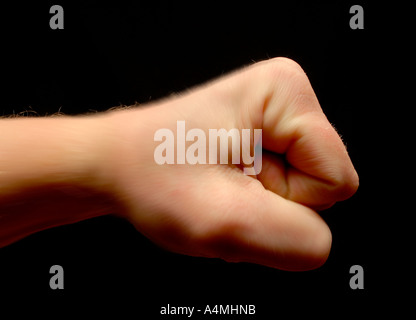 Fist in profile on black background Stock Photo