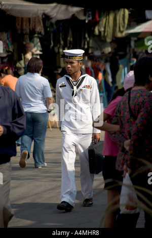 Young Sailor walking through Chatuchak Market Bangkok Thailand Stock Photo