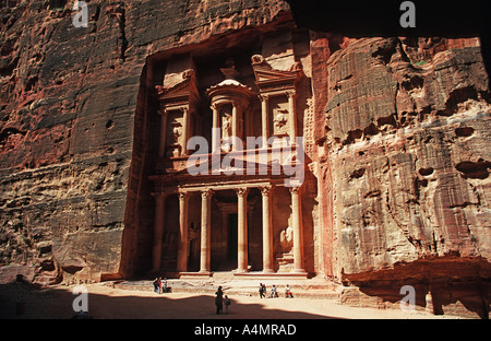 Tourists standing in front of the Treasury at Petra also known as El Khazneh Nabataean carved facade Petra Jordan Middle East Stock Photo