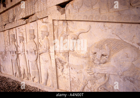 Scene from Persian mythology in the Apadana stairs, Persepolis, Iran Stock Photo