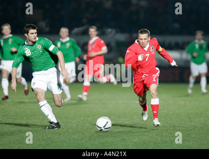 Craig Bellamy 7 of Wales and Liverpool chases the ball pursued by Aaron Hughes 18 during International Friendly match Stock Photo