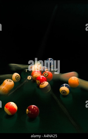 Action shot of pool balls rolling on pool table with motion trails Stock Photo