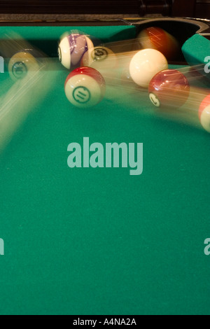 Action shot of pool balls in motion on pool table Stock Photo