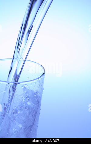Pouring glass of water Stock Photo