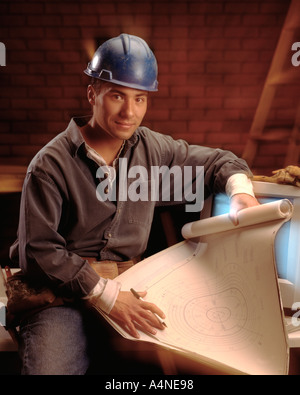 construction worker at work site with blueprints Stock Photo