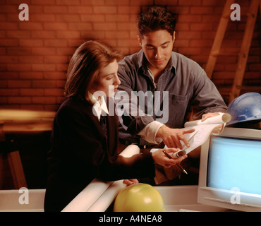 construction worker and architect at work site with blueprints Stock Photo