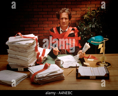 businessman tied up in red tape Stock Photo