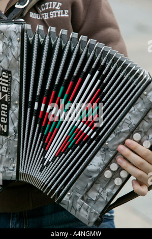 Young Basque man playing traditional Basque accordion with Ikurrina flag, Plaza Nueva, Bilbao, Basque Country Stock Photo