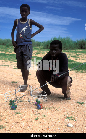 Ovambo tribe boys with self made toy car made of wire near Kamanjab Ovamboland Namibia Africa Stock Photo