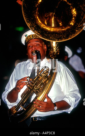 Man plays sousaphone marching with band through French Quarter New Orleans Louisiana USA Stock Photo