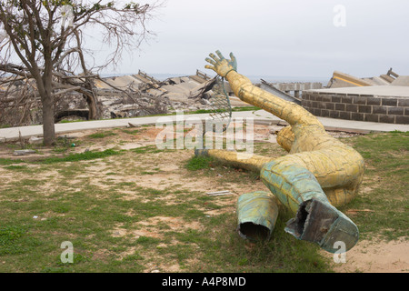 Golden Fisherman statue broken from its foundation lies on ground six months after Hurricane Katrina devastates Biloxi Mississippi USA Stock Photo