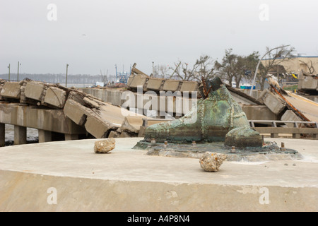 Boot of Golden Fisherman statue with destroyed Ocean Springs Bridge in background six months after Hurricane Katrina in Biloxi Mississippi USA Stock Photo