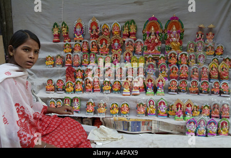 Girl selling statues of Hindu Gods in Chandni Chowk in Delhi India Stock Photo