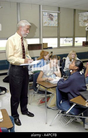 Middle school male teacher interacts with students in an 8th grade class Stock Photo