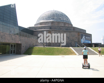 person on a segway in front of the Adler planetarium and astronomy museum chicago  illinois Stock Photo