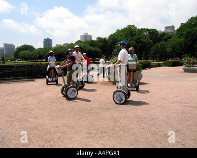 People riding segway personal transporters in a city Stock Photo