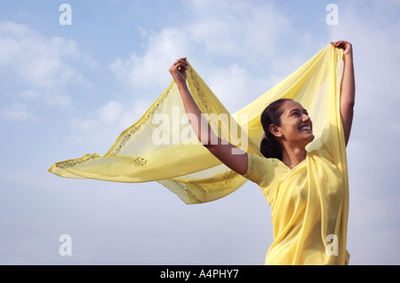 A young indian woman joyfully waving her arms in the air Stock Photo ...