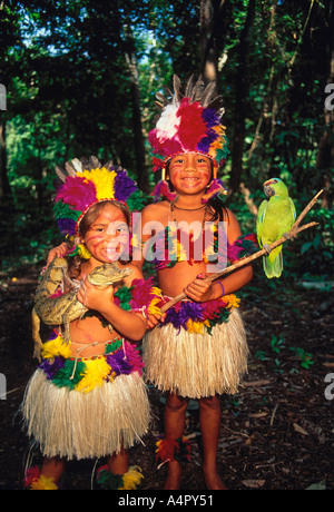 2, two, Brazilian girls, green parrot, caiman, on Terra Nova Island along the Amazon River east Manaus in Amazonas State, Brazil, South America Stock Photo