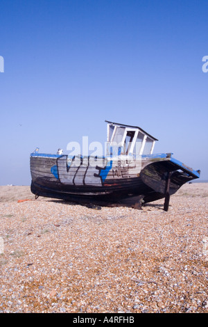 Decaying hull of an old wooden fishing boat abandoned on the shingle ...