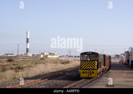 The Romney, Hythe and Dymchurch railway stops at Dungeness in Kent.  The new lighthouse can be seen in the background Stock Photo