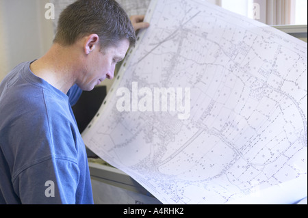 man studying a detailed map of his local area Stock Photo - Alamy